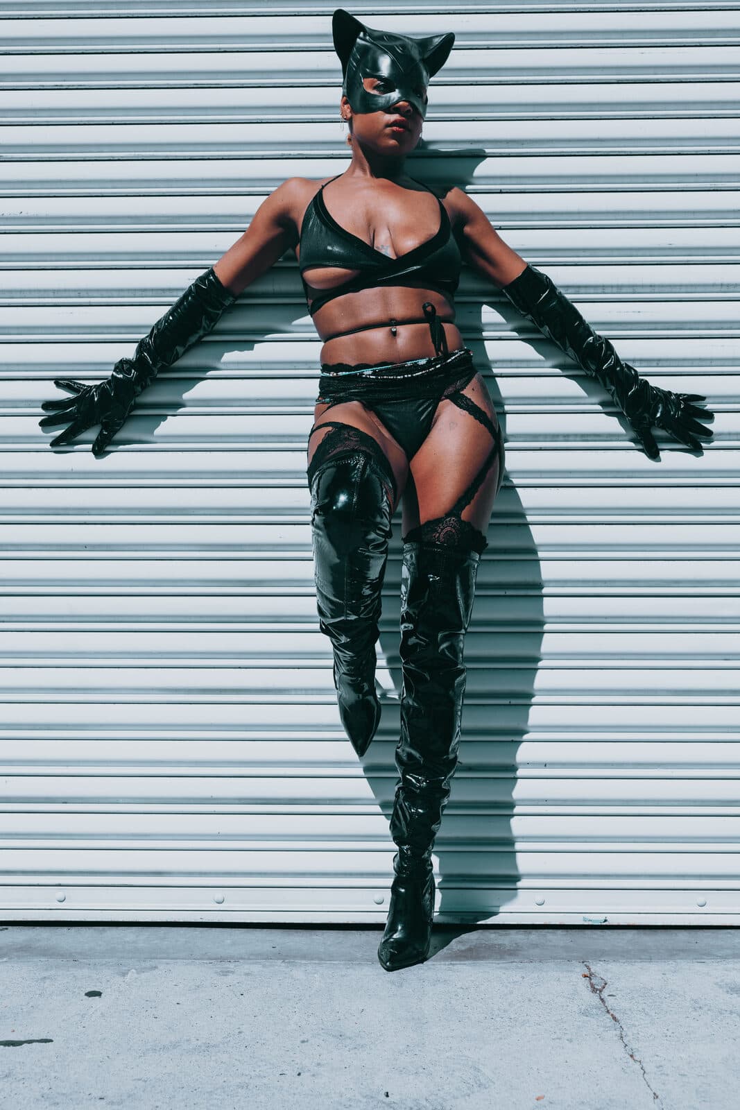Winged costume editorial against white wall
