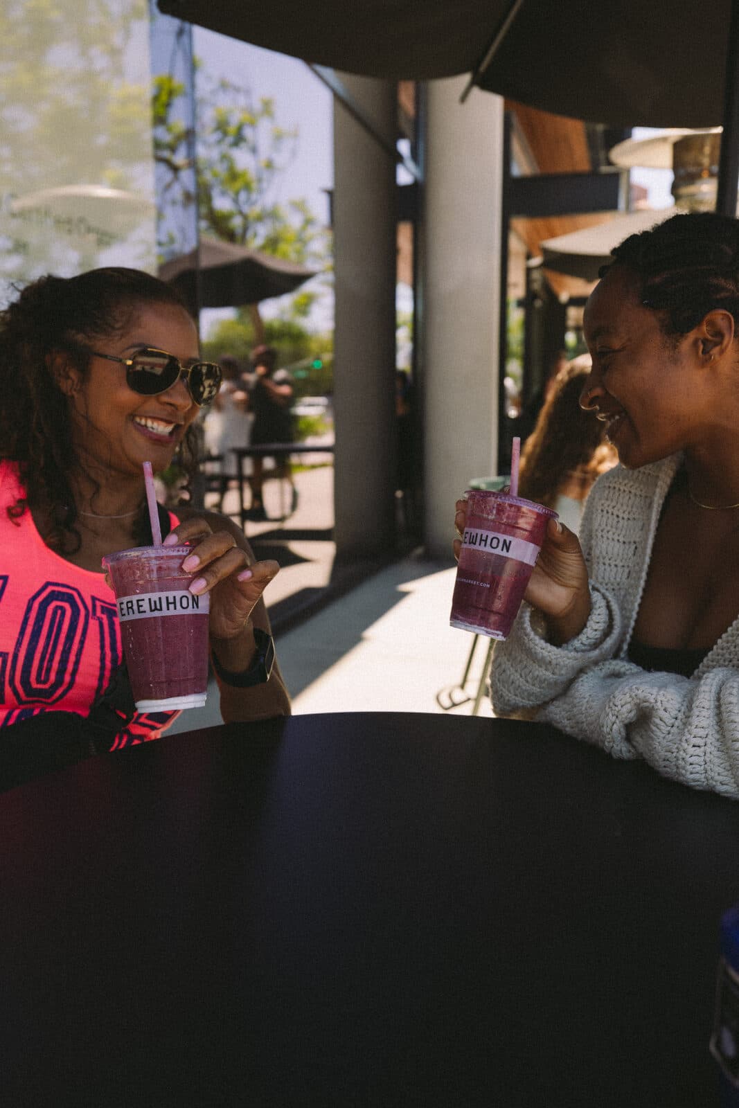 Friends sharing drinks at an outdoor cafe