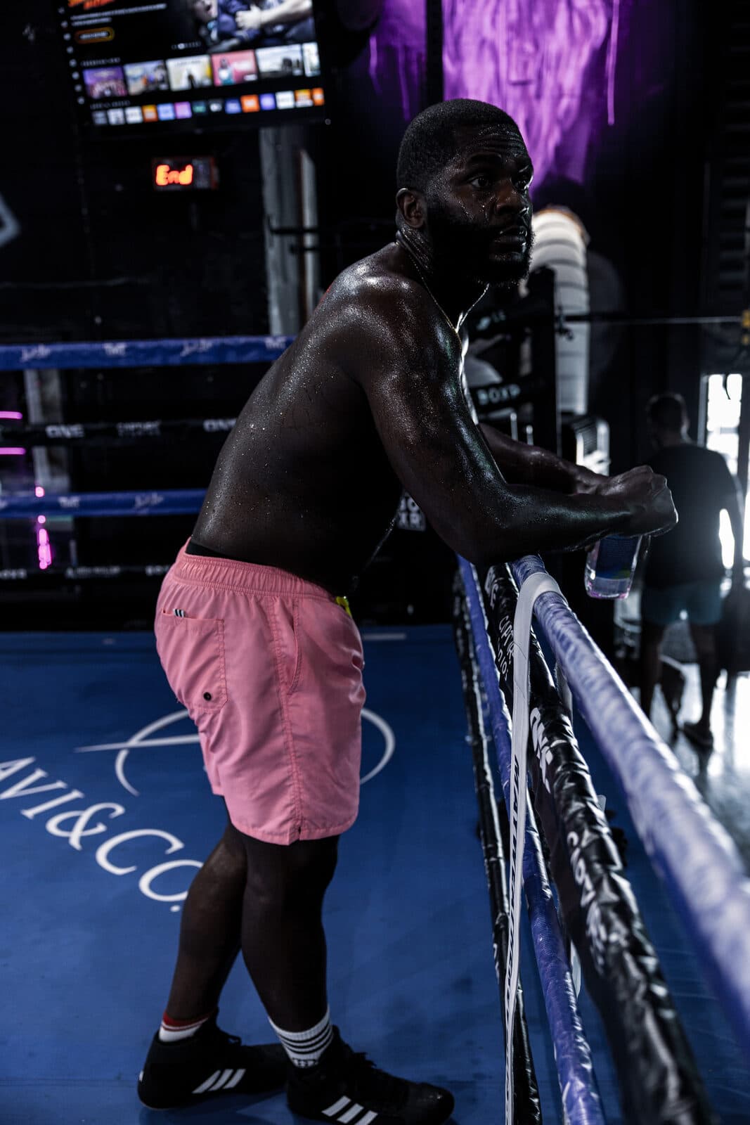 Boxer resting on the ropes between rounds
